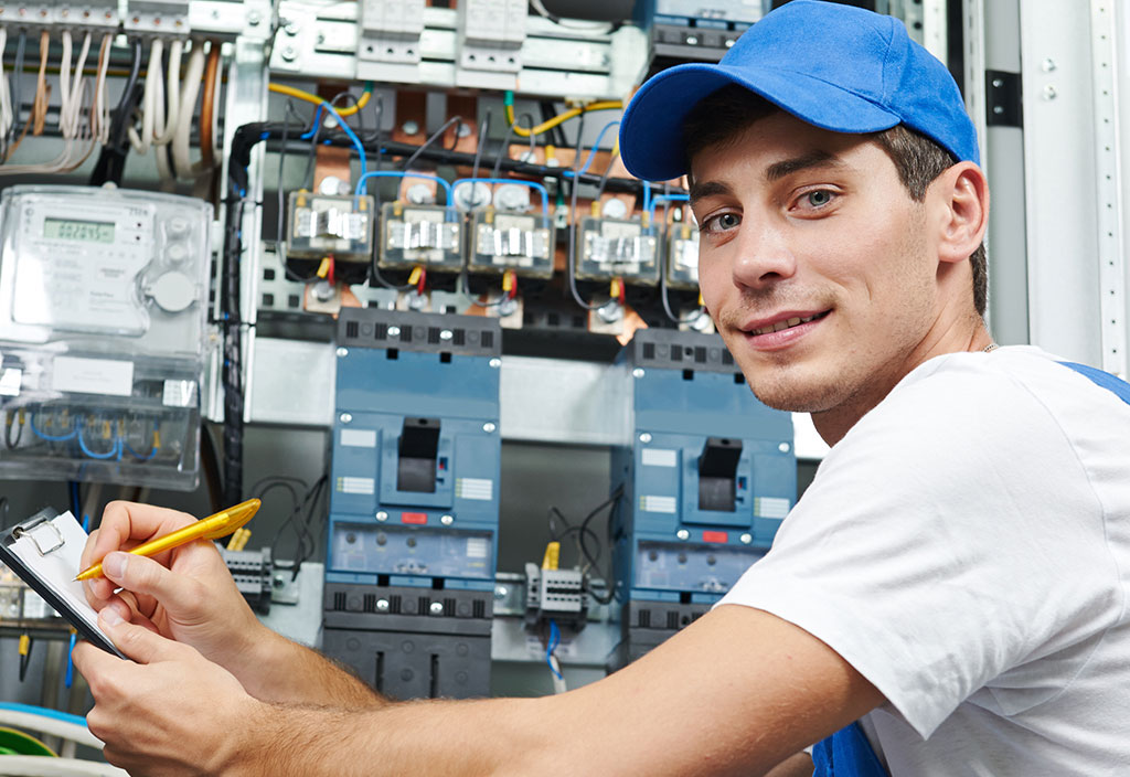 Worker inspecting equipment and electricity meter